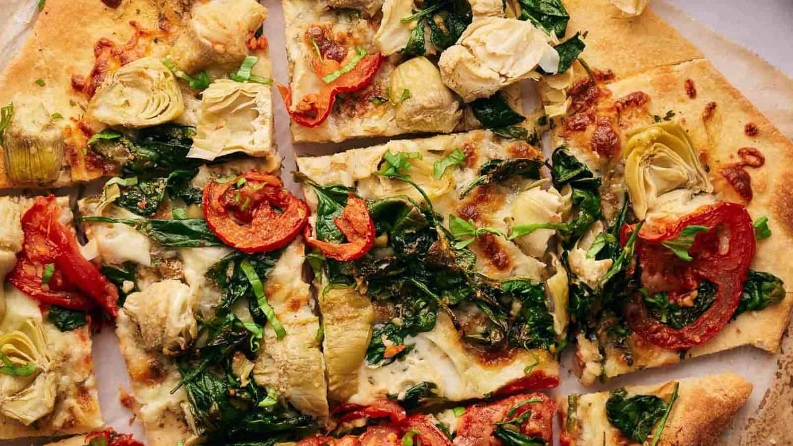 Four tortilla pizzas on a wooden cutting board.