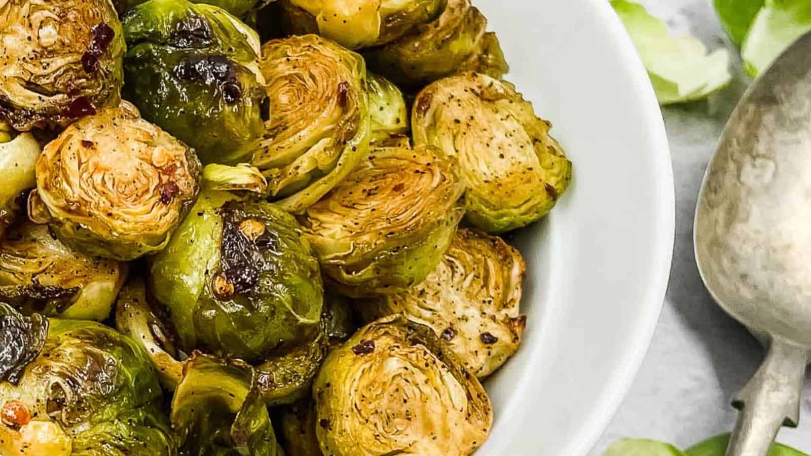 Roasted brussels sprouts in a white bowl.