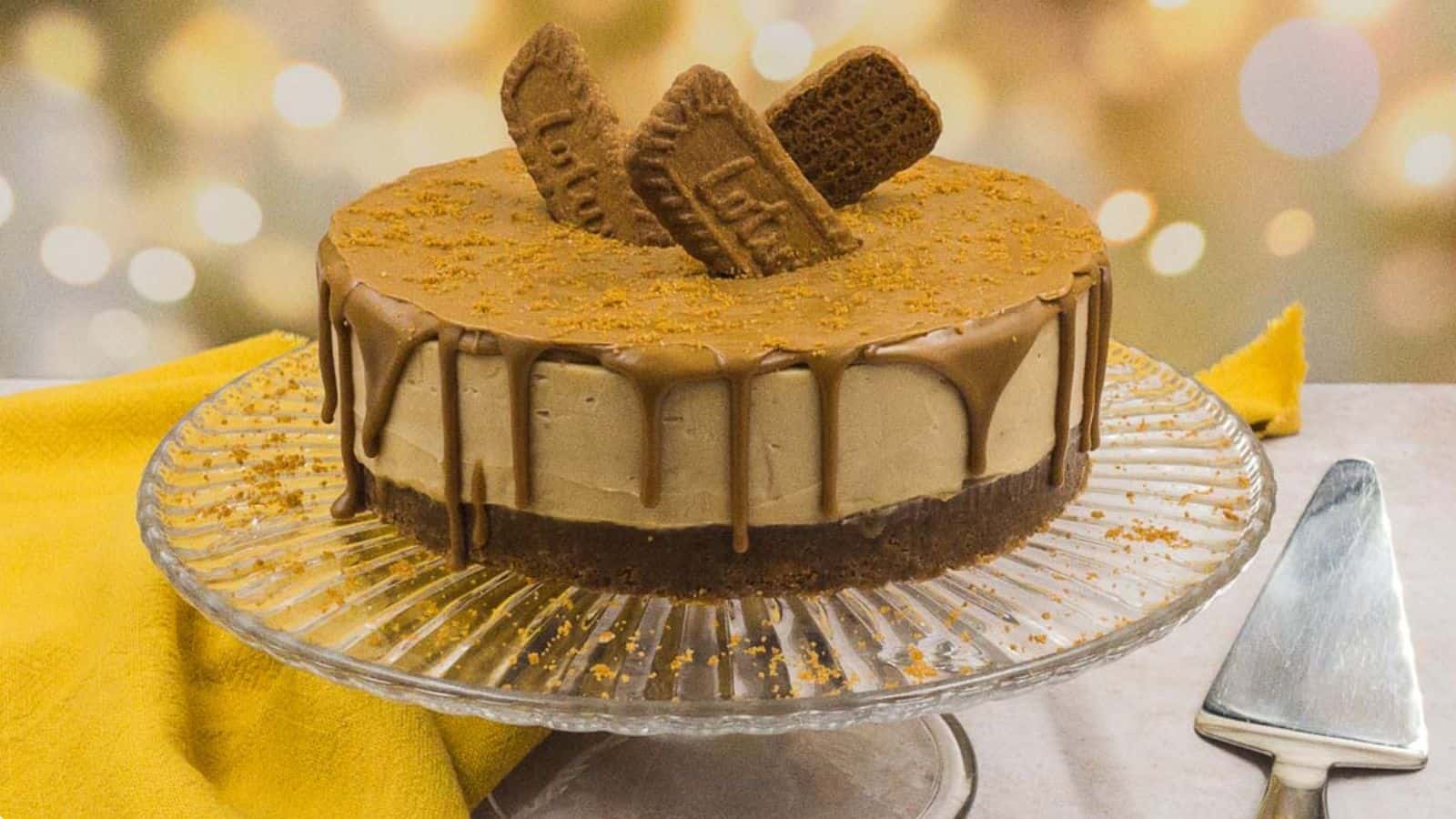 A homemade Biscoff cheesecake is delicately placed on a plate, accompanied by a knife and fork.