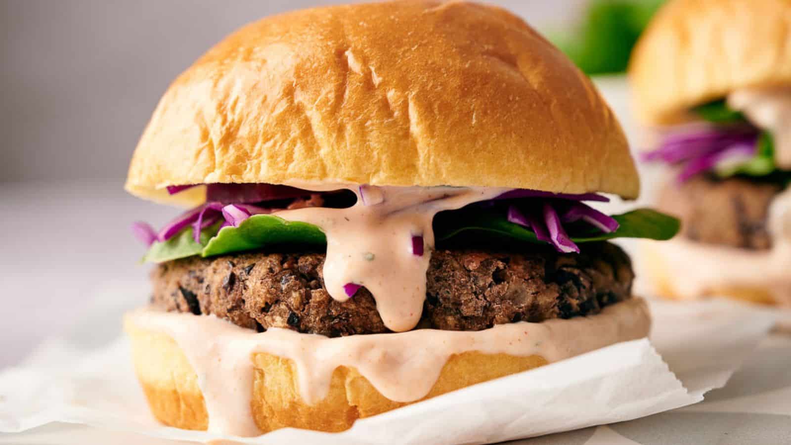 Two homemade black bean burgers in buns ready to eat.