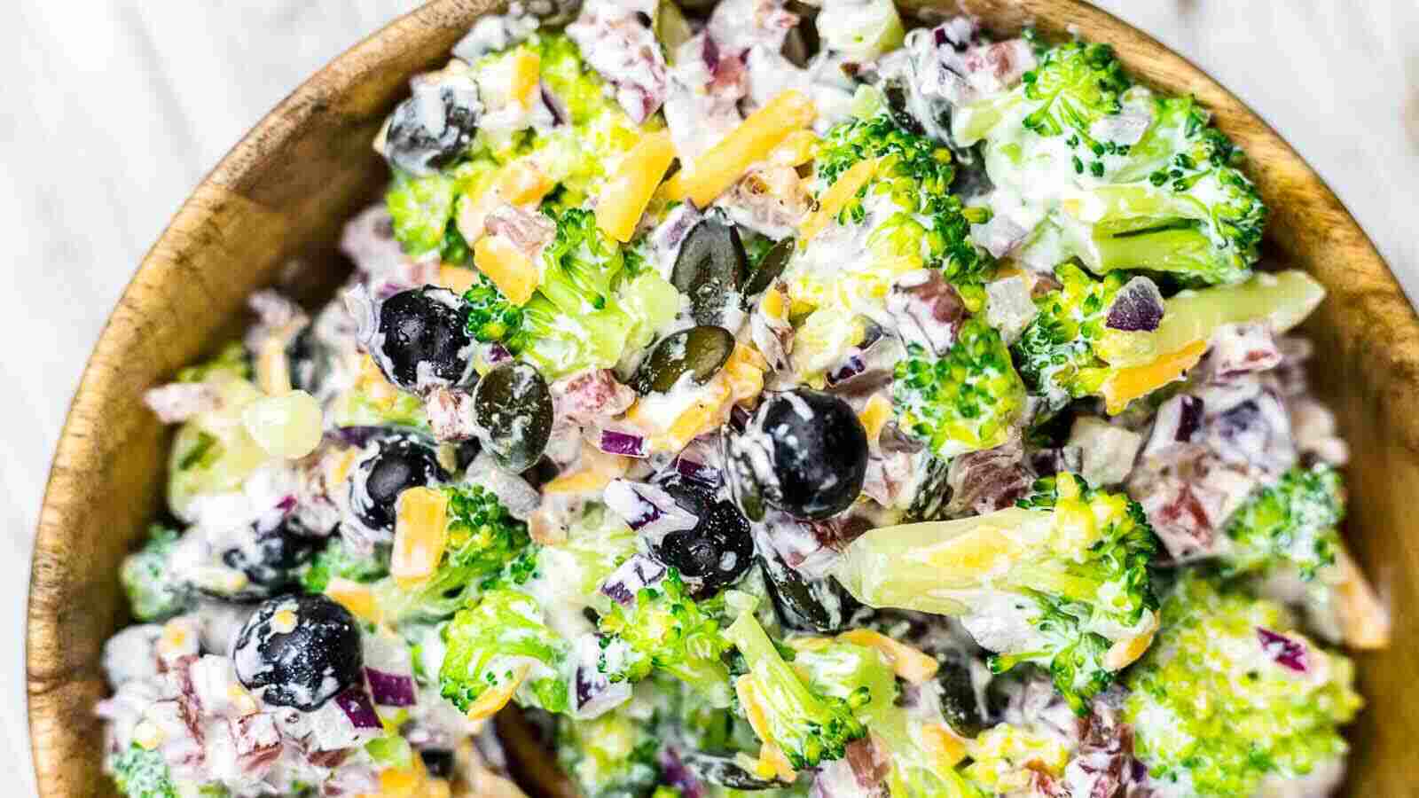 Broccoli Salad with Bacon inside wooden bowl. 