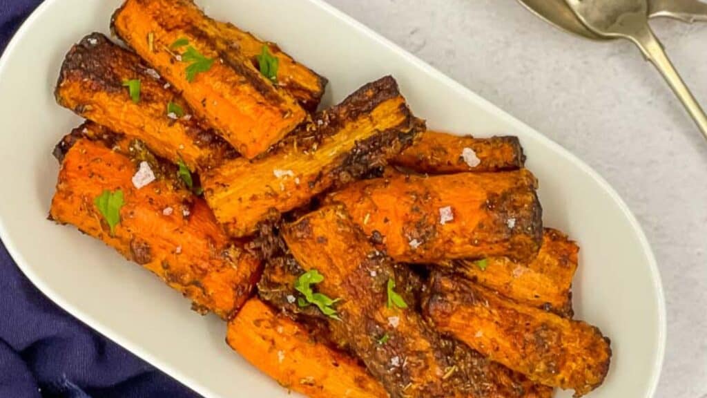 Roasted sweet potato wedges on a white plate.