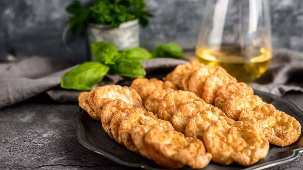 Cloud Egg Crisps on a plate with wine in the background.