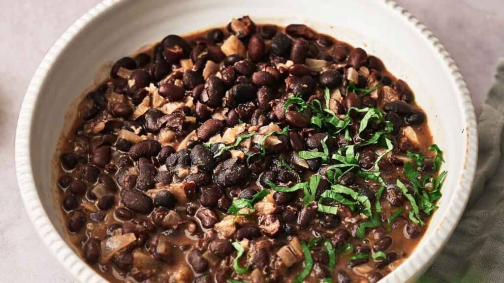 Black beans in a white bowl.