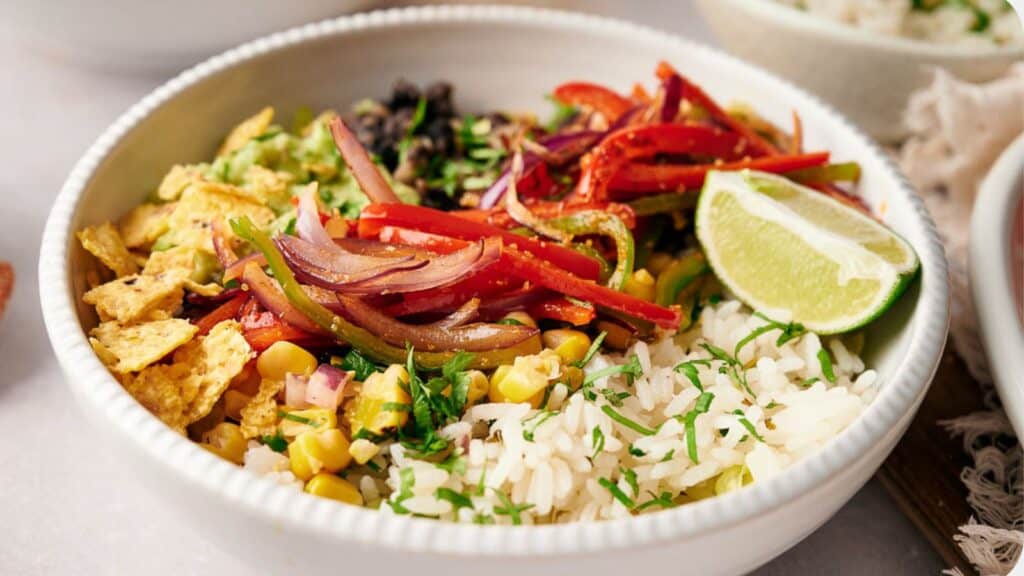 A bowl of mexican food on a table.