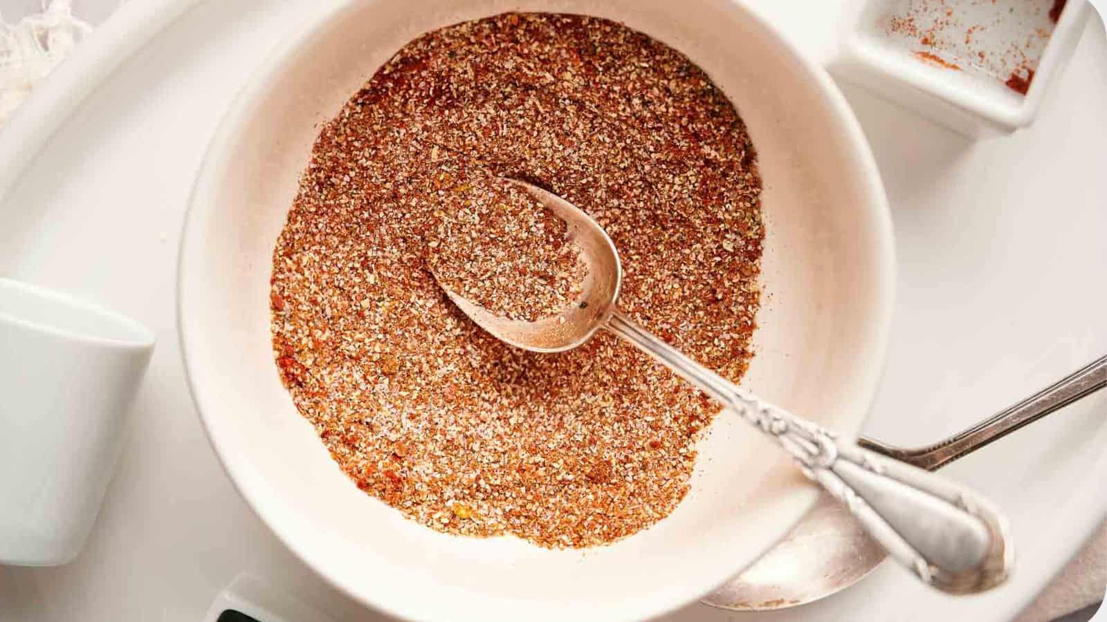 Homemade fajita seasoning in a bowl with a spoon in it.