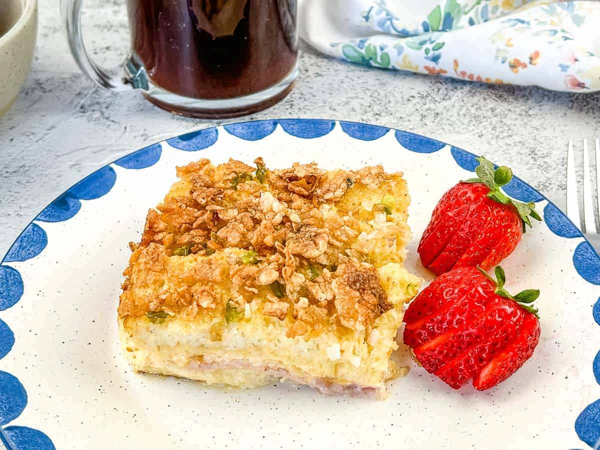 A closeup shot of breakfast casserole on a plate with berries.