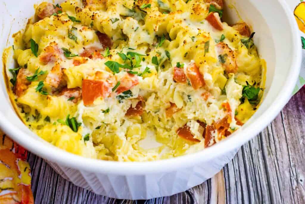 A white bowl with a dish of Pasta with Ricotta & Tomatoes.