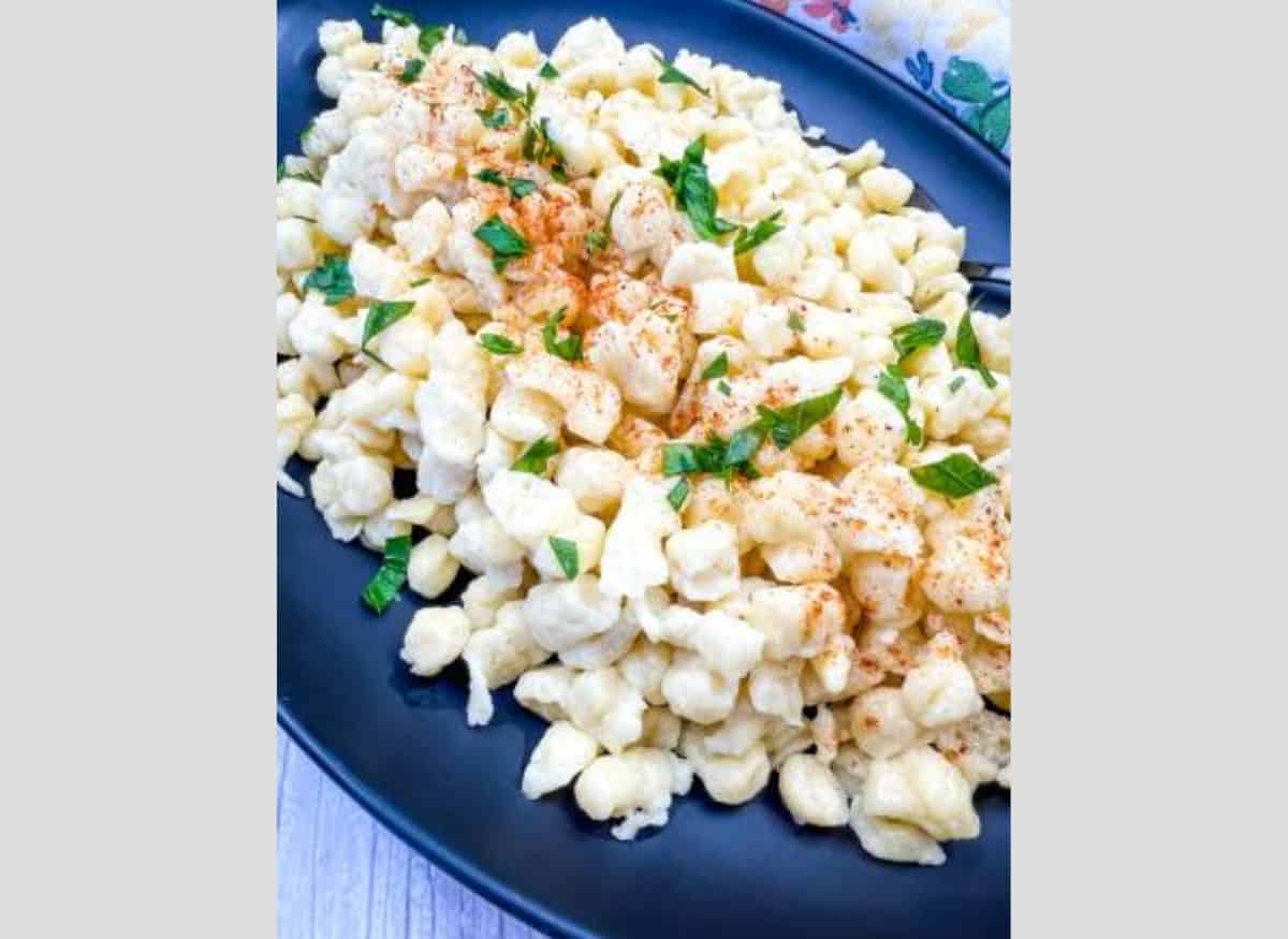 A plate of Authentic German Spaetzle garnished with parsley.