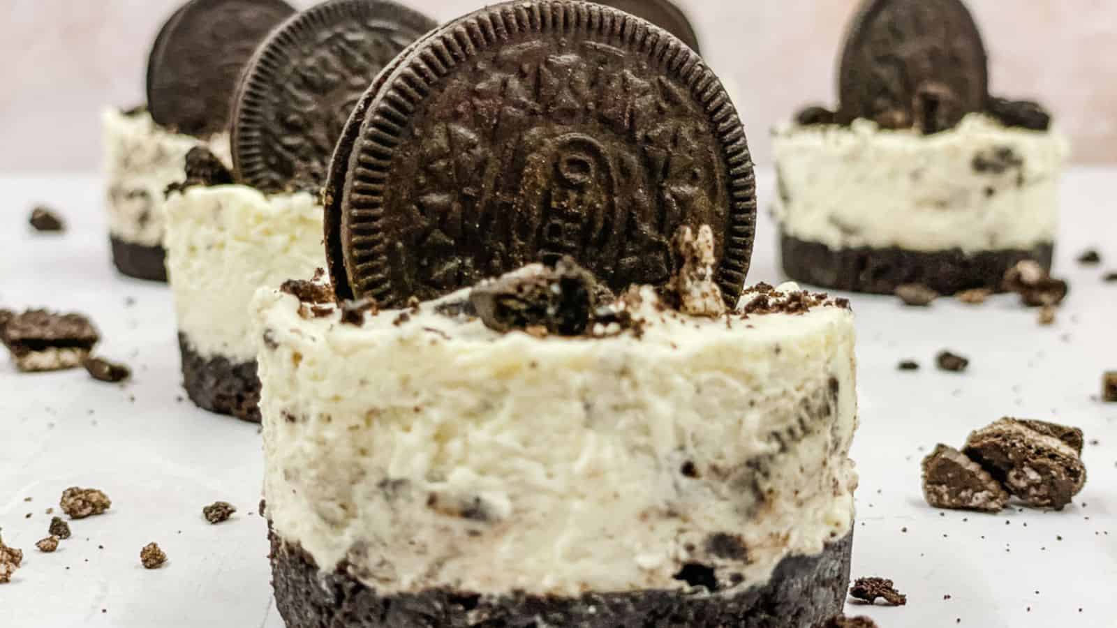 Homemade Oreo cheesecakes topped with Oreo cookies.