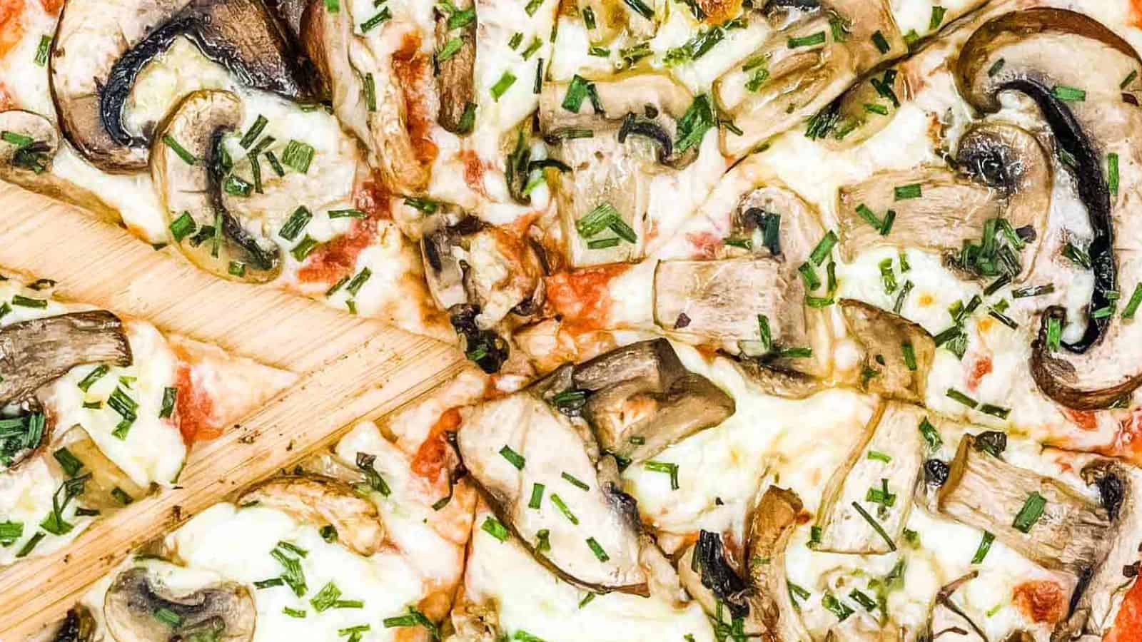 Mushroom pizza sliced and ready to eat.