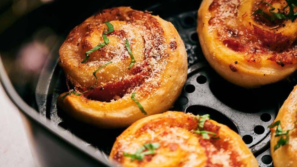 A frying pan is filled with a bunch of fried pastries.