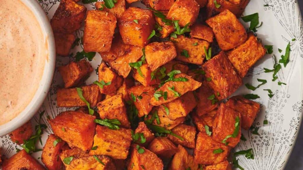 Sweet potato fries with a dip on a plate.