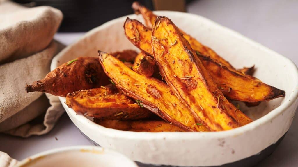 Sweet potato fries in a bowl on a table.