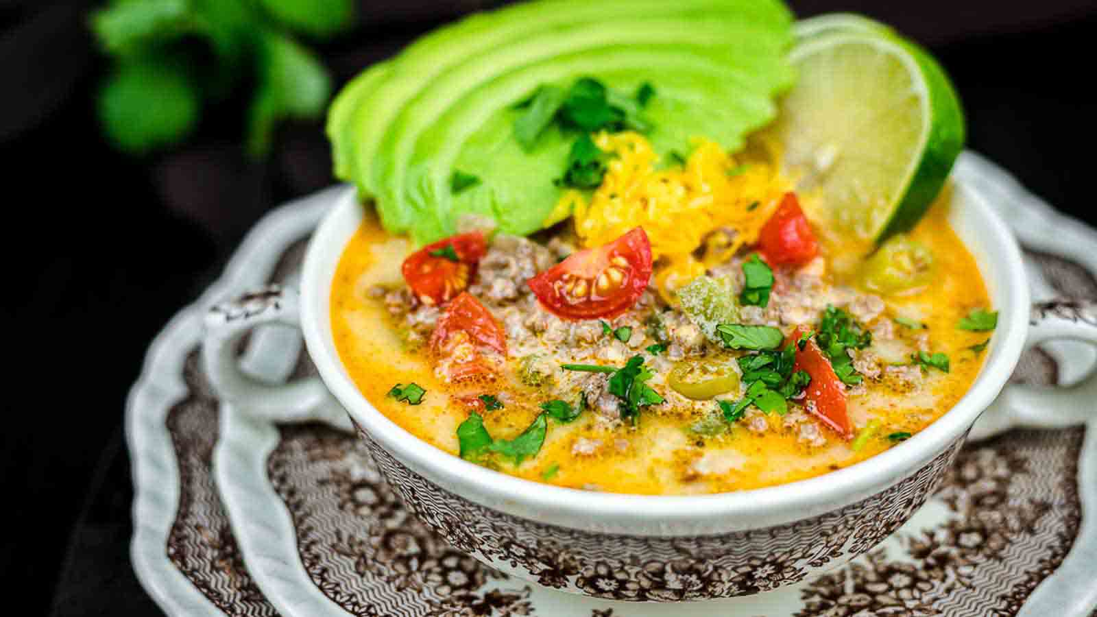 Creamy Keto Taco Soup with gresh avocado slices and lime. 