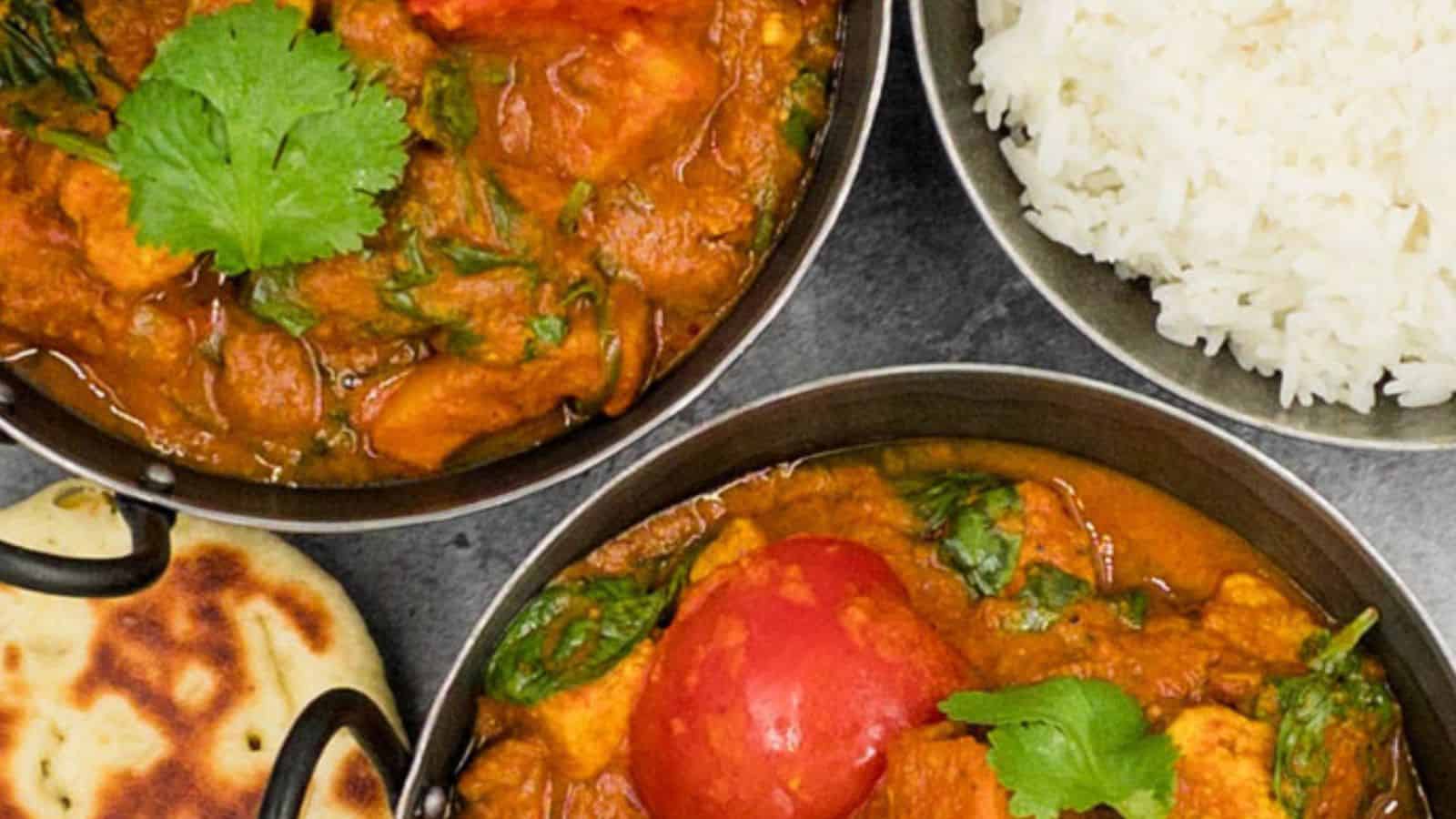 Three bowls of international potato  curry with rice and naan.