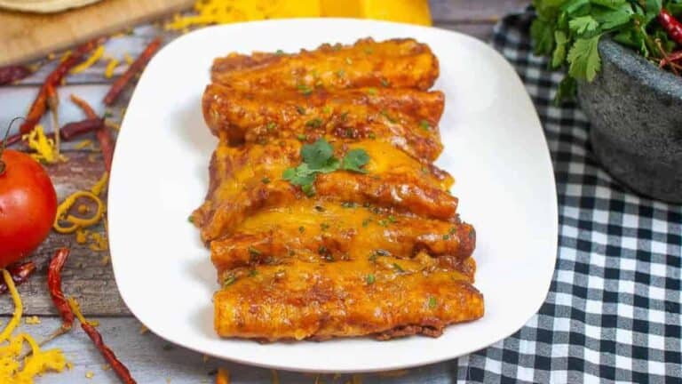 Mexican enchiladas on a white plate.