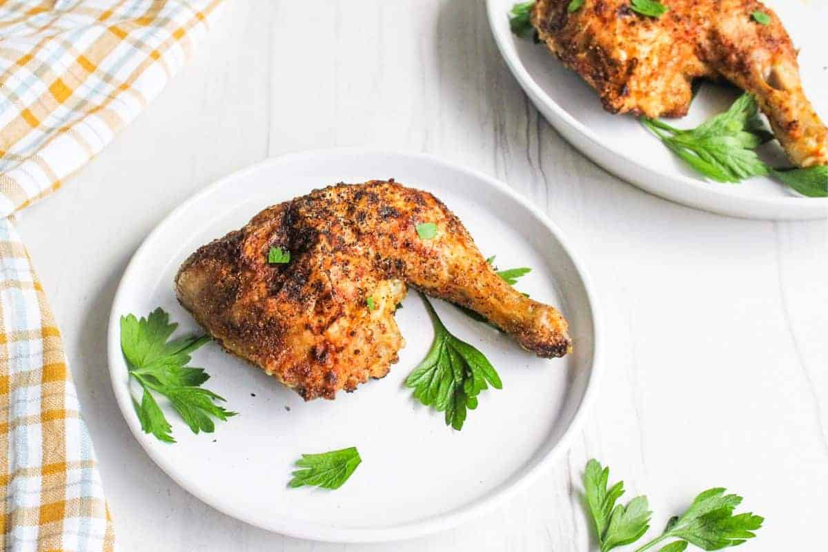 Air fried chicken leg quarters served on plates.