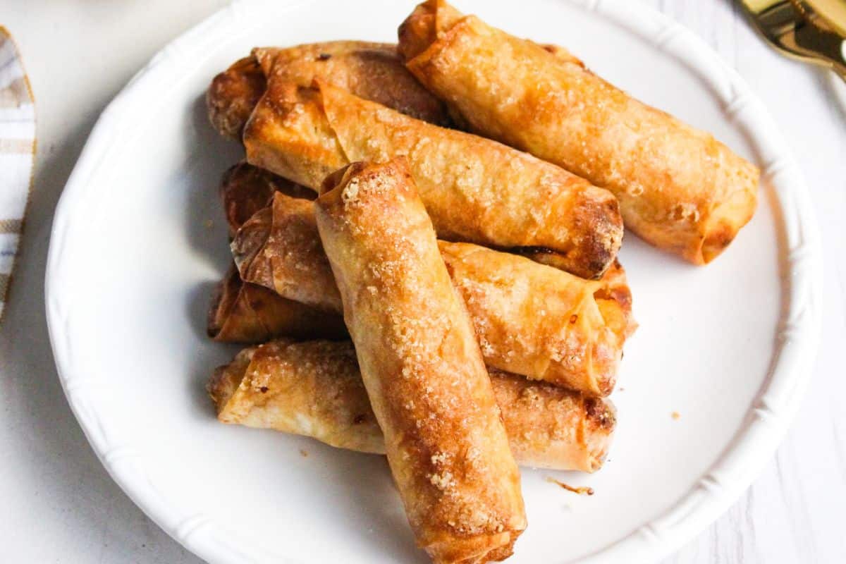 Fried Filipino banana turon lumpia on a white plate.