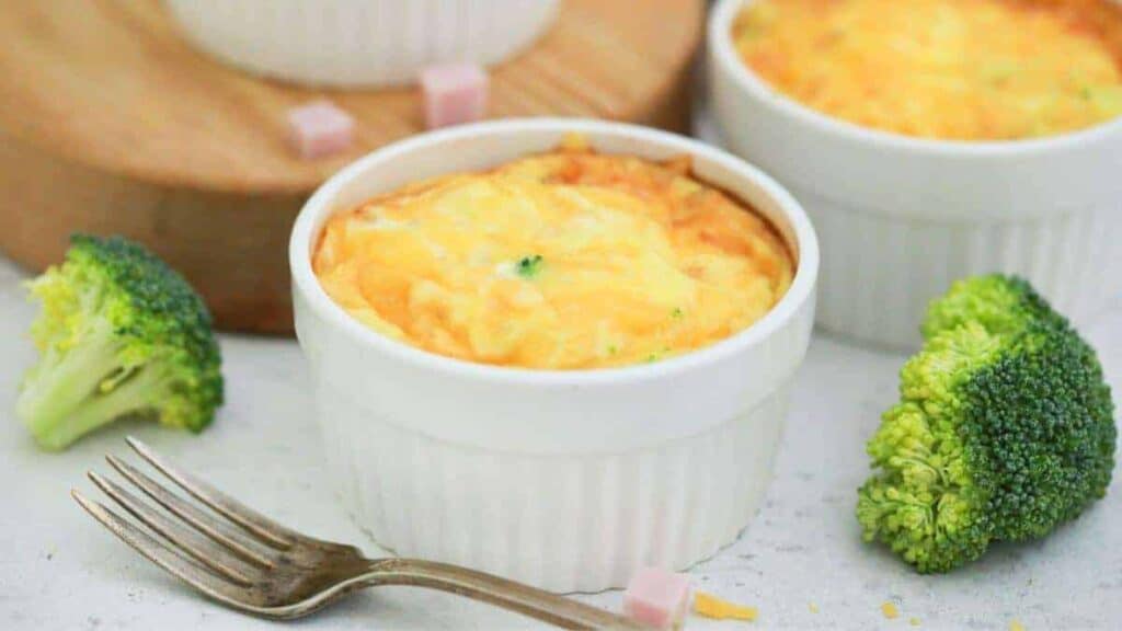 A bowl of broccoli and ham quiche with a fork.