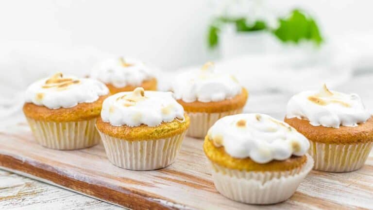 Almond Flour Cupcakes on a wooden board with meringue icing.