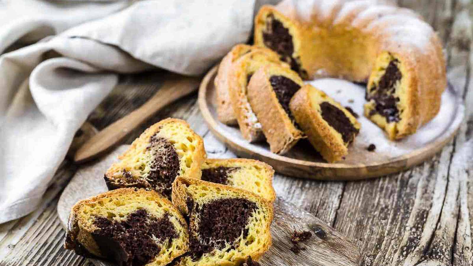 Marble Chocolate Bundt Cake cut into slices on a wooden table. 