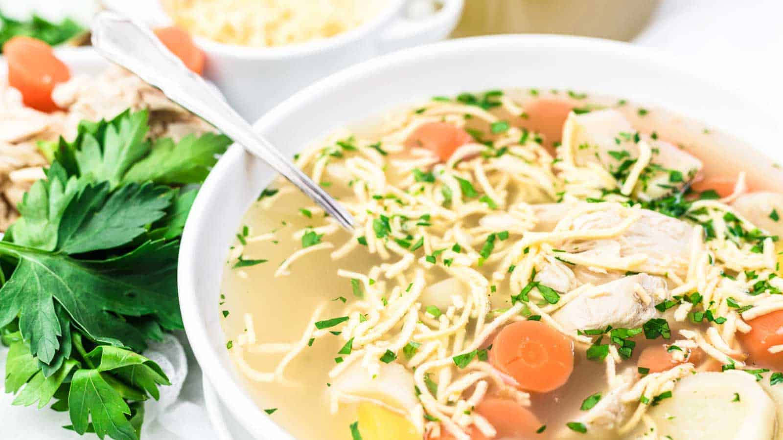 Chicken Noodle Soup with Homemade Keto Egg Noodles in a white bowl.