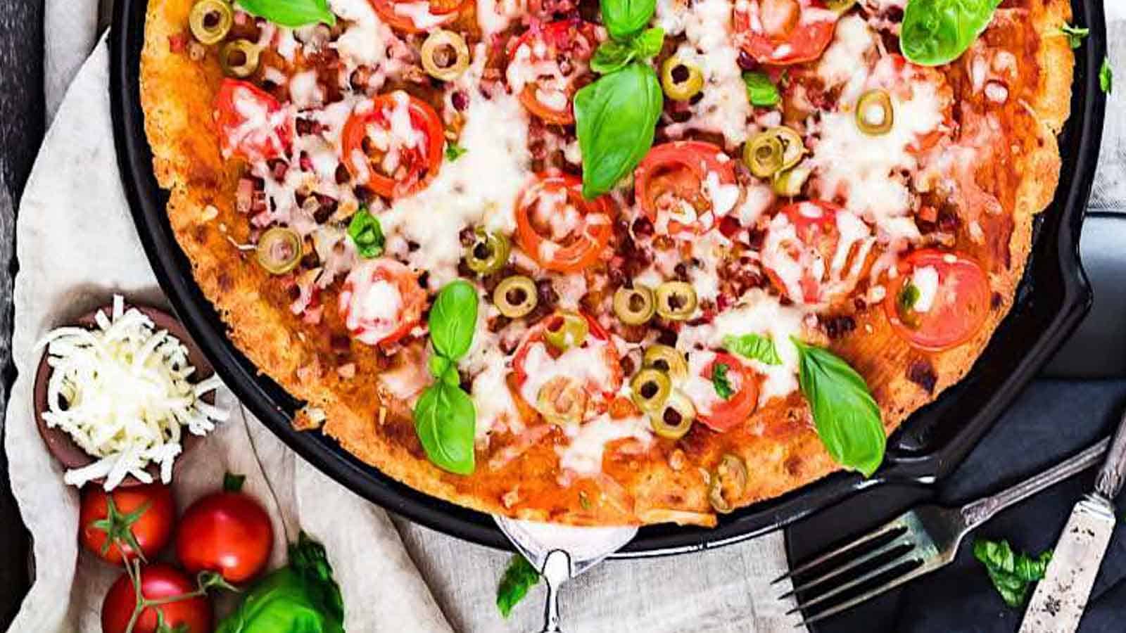 Bacon Fathead Pizza with fresh basil leaves. 