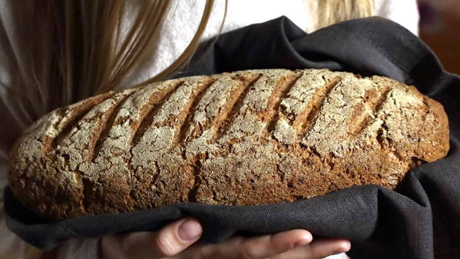 Girl holding Farmers Bread loaf. 