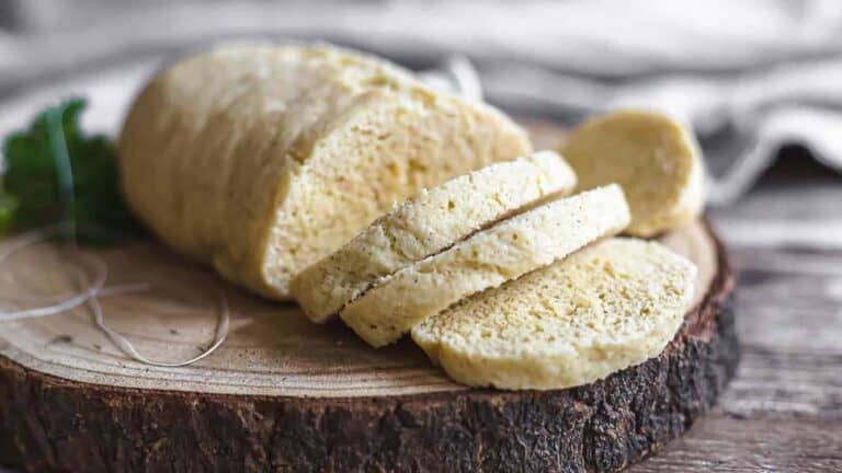 Keto steamed bread on a wooden board sliced.