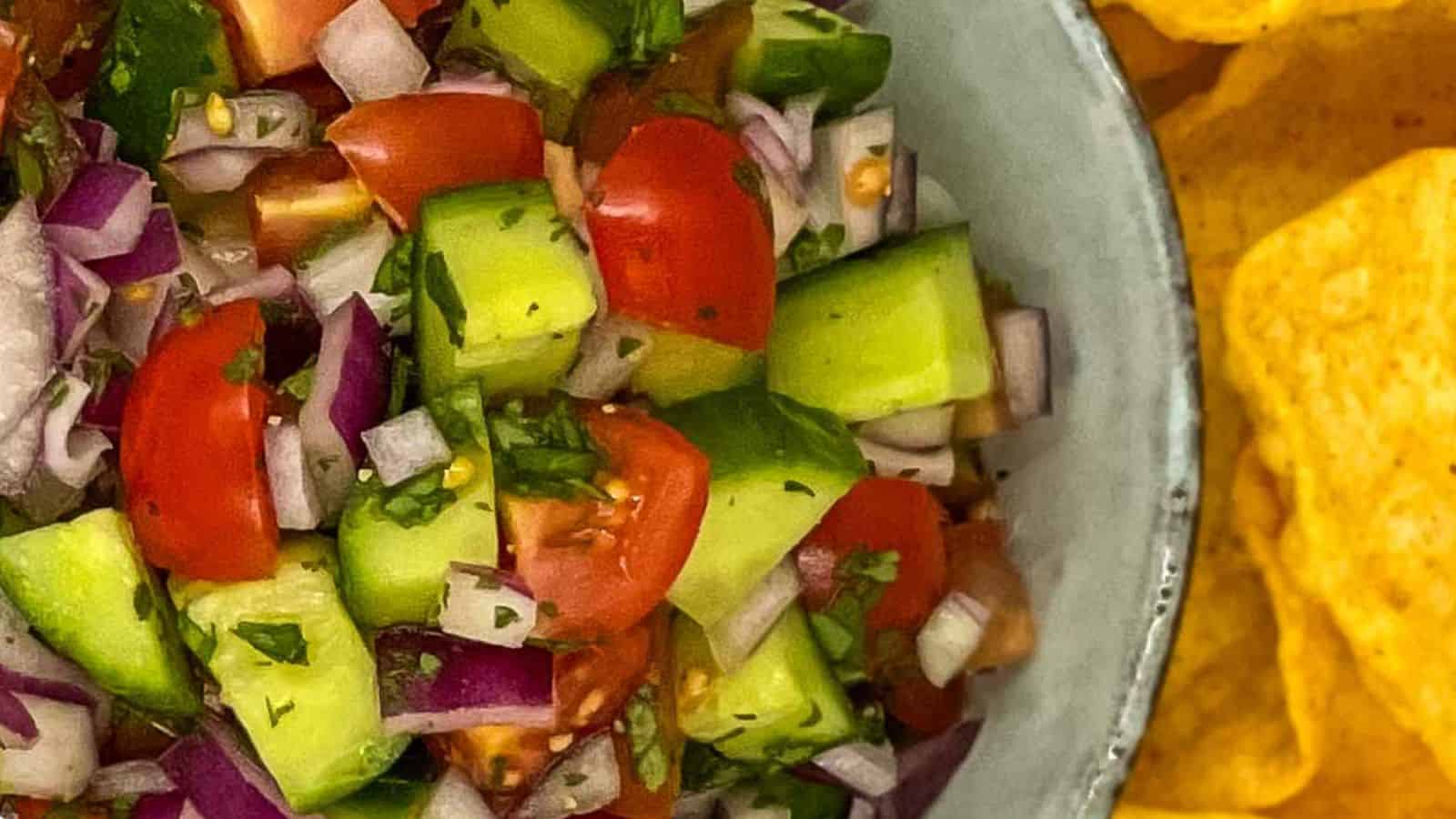 Chunks of tomato, cucumber, and onion in a bowl.