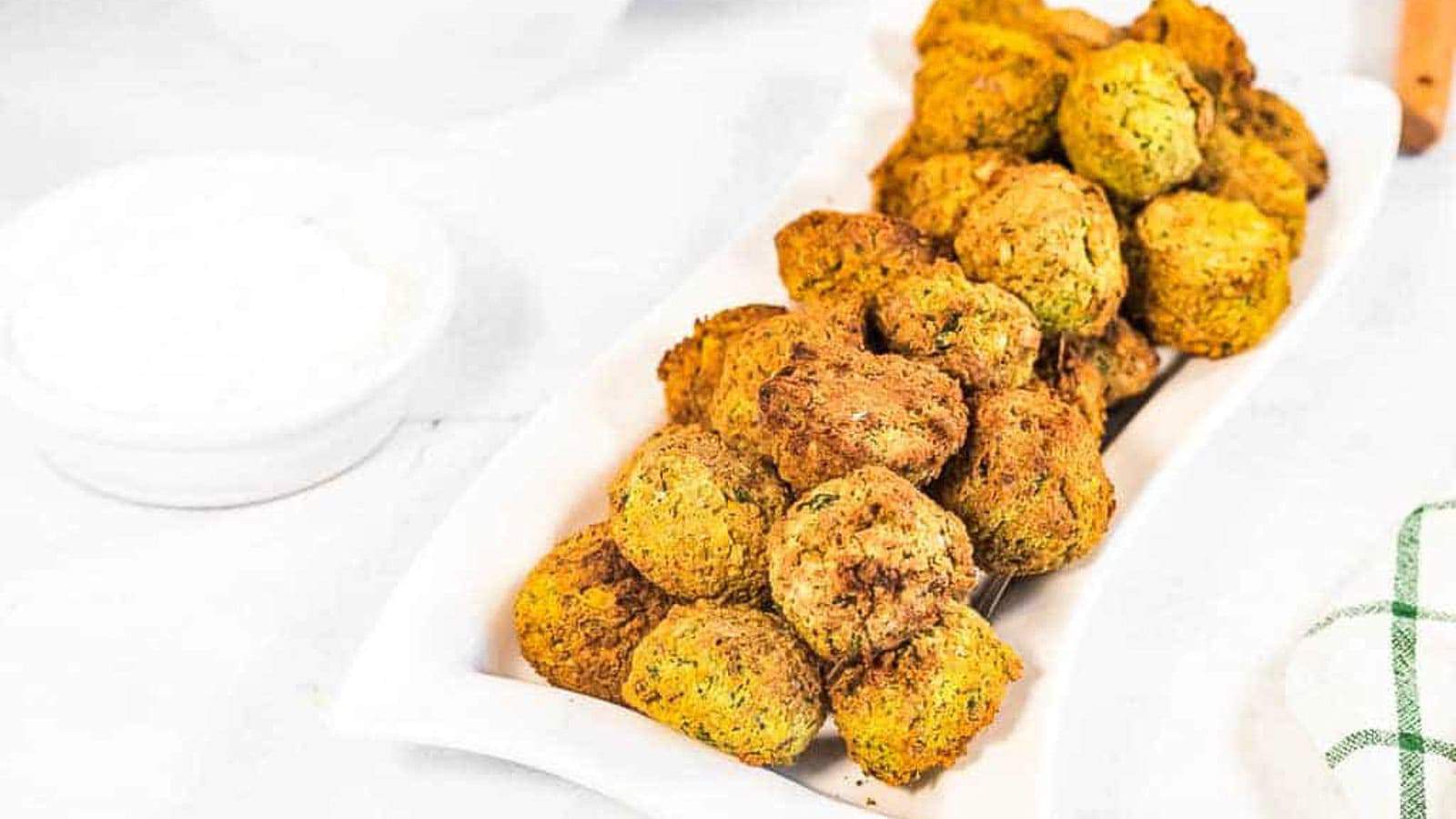 Low angle shot of a platter of air fried falafel patties.