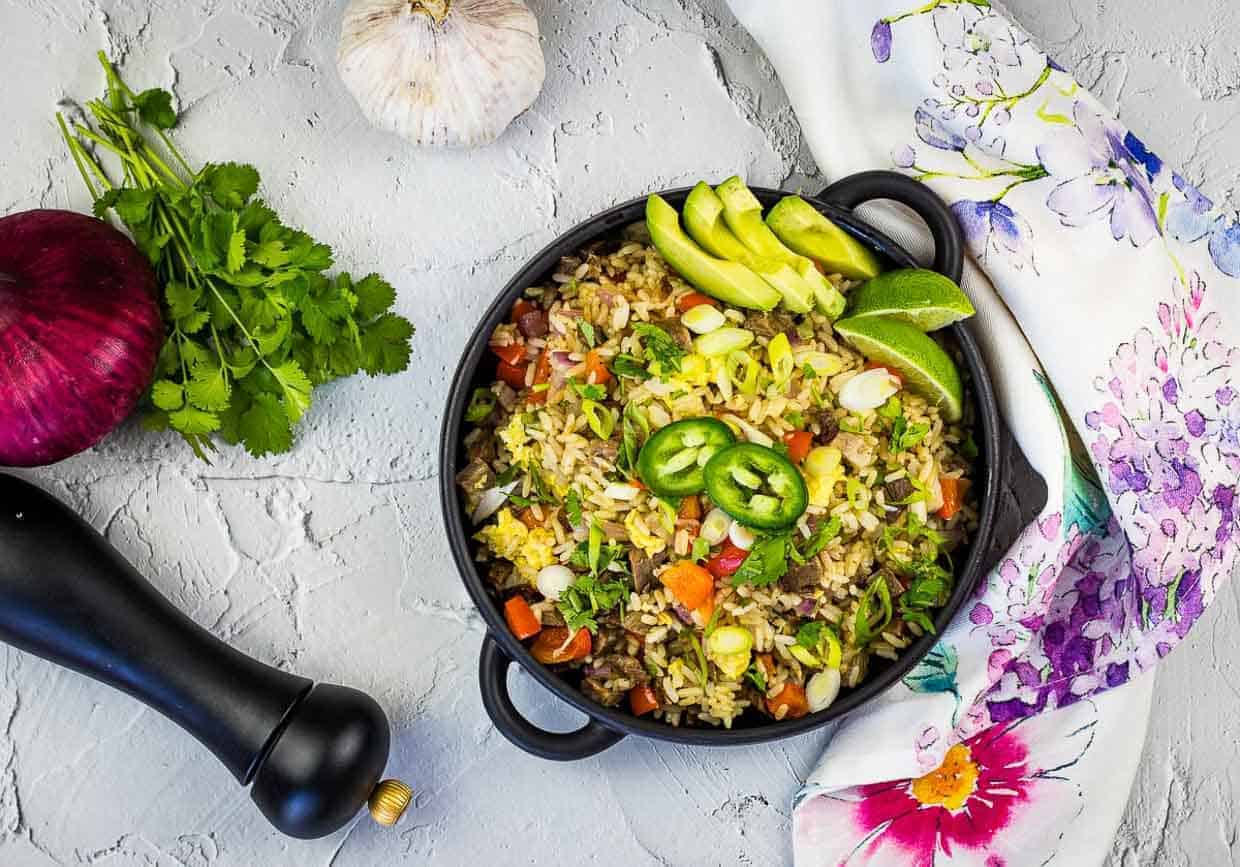 Brisket fried rice in black serving dish on white background.