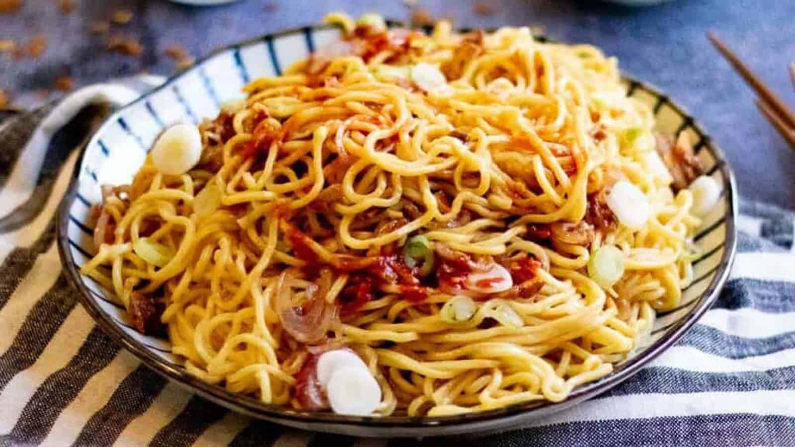 Low angle shot of a plate of burmese garlic noodles.