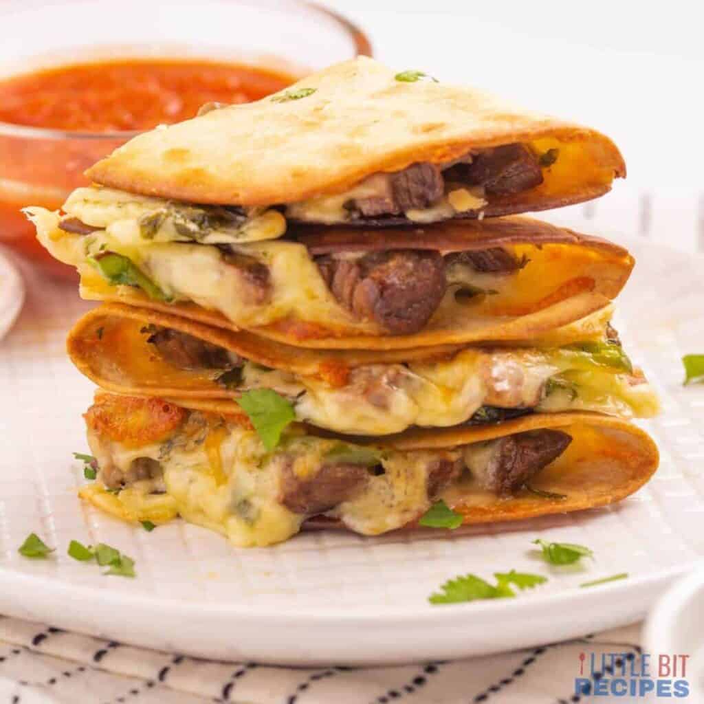 Stack of beef quesadillas on a plate.