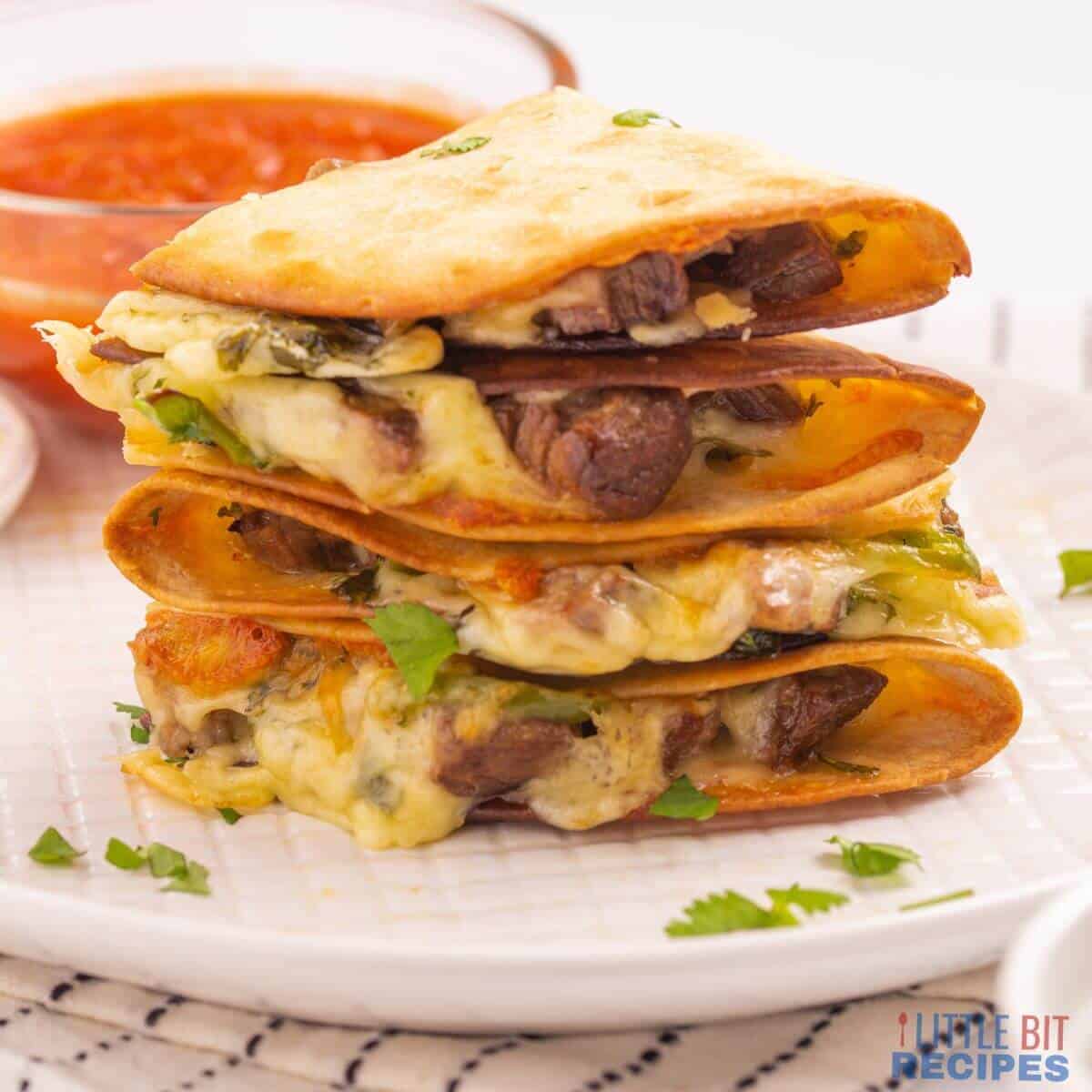 Slices of baked carne asada on small wood cutting board.