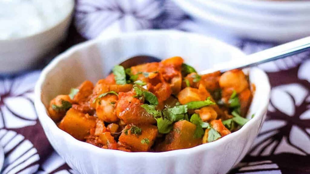 Chickpea curry in a bowl on a table.