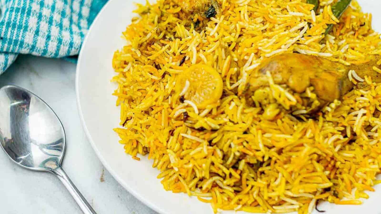 Chicken biryani on a plate with raita.