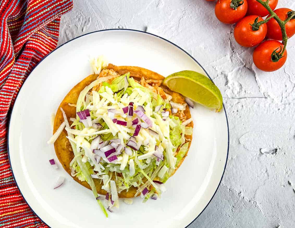 Chicken Tinga Tostada on a plate.