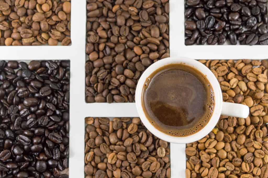 Coffee beans and a cup of coffee on a white background.