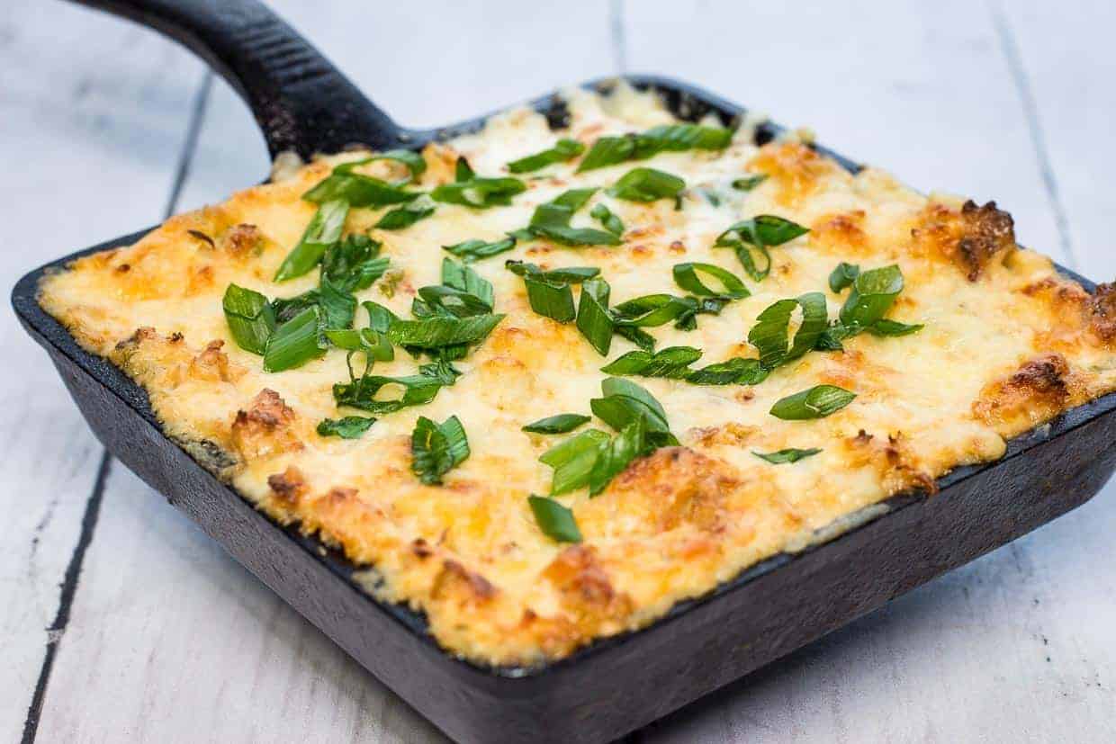 A closeup of Crab Rangoon Dip in a black dish.