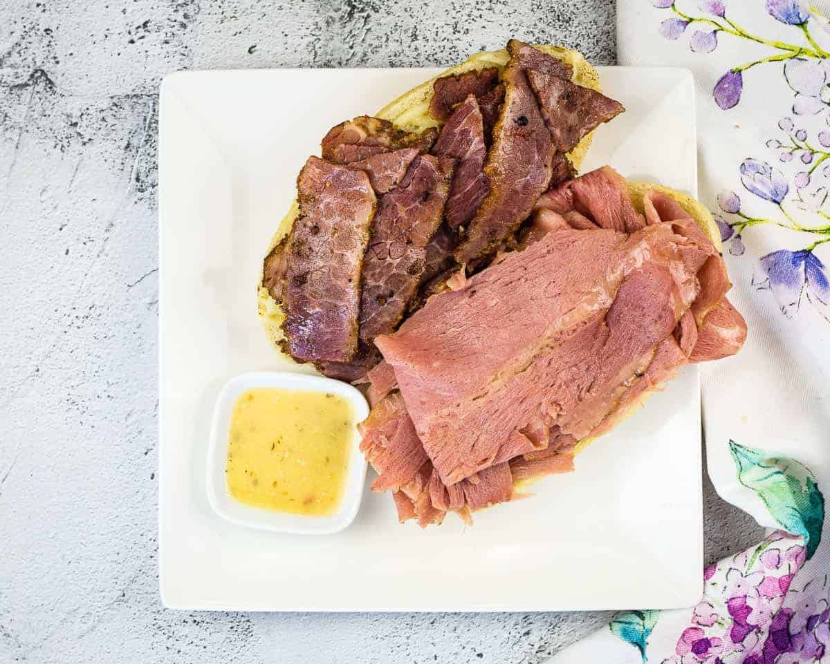 An open-face NY Steamer sub copycat on a plate with Italian dressing.