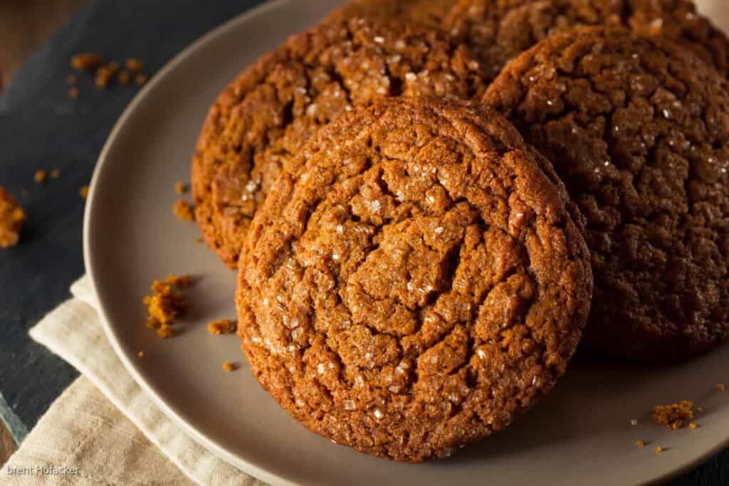 A plate of ginger cookies on a wooden table.