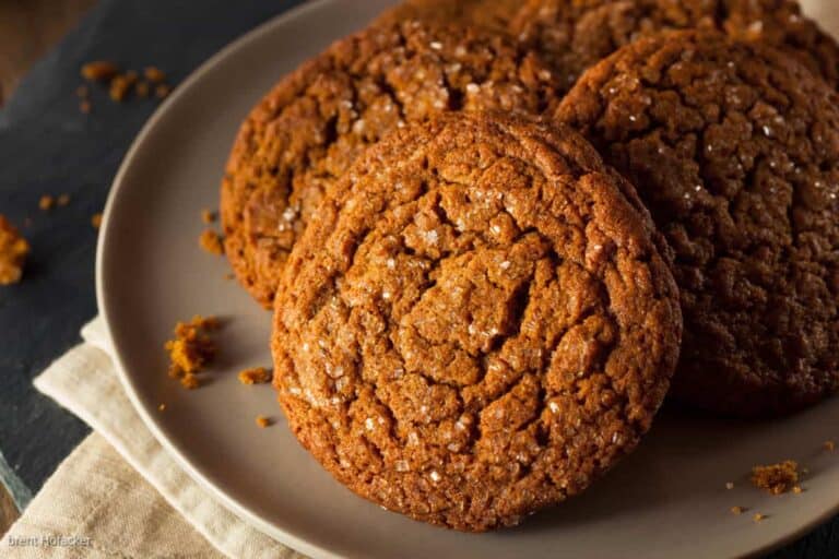 Low angle shot of a single gingersnap cookie broken in half.