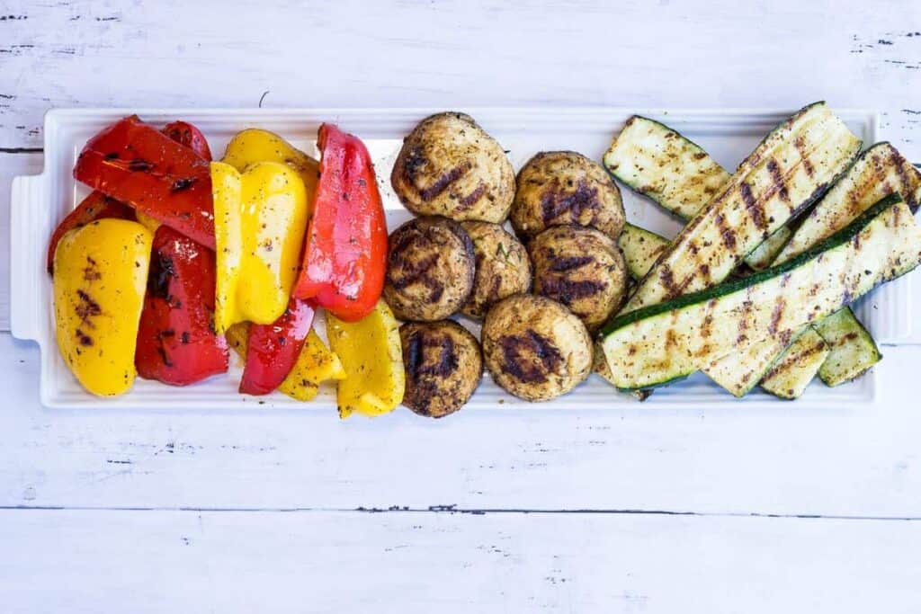 Grilled vegetables on a white platter.