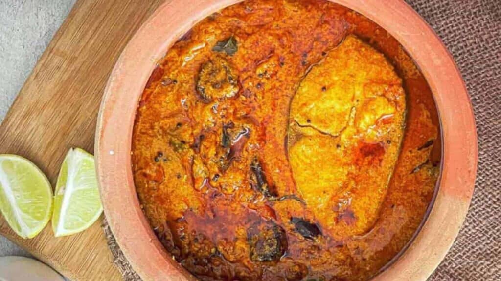 Fish curry in an earthenware baking dish.