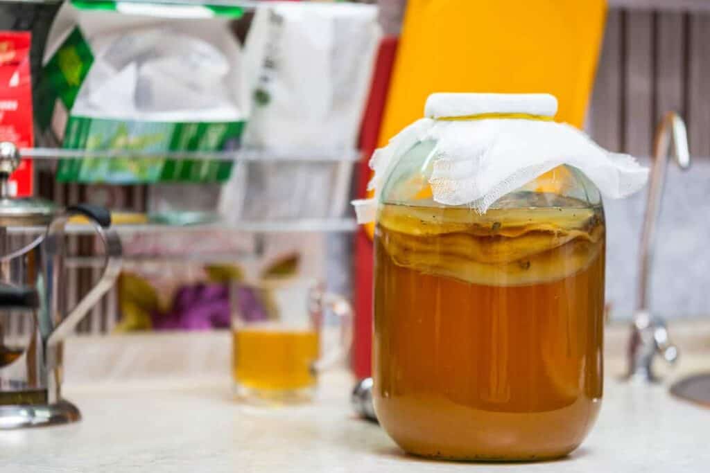 A jar of honey sitting on a counter.