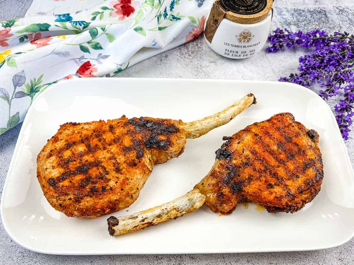 Ninja Grilled Tomahawk Pork Chops on a white plate.