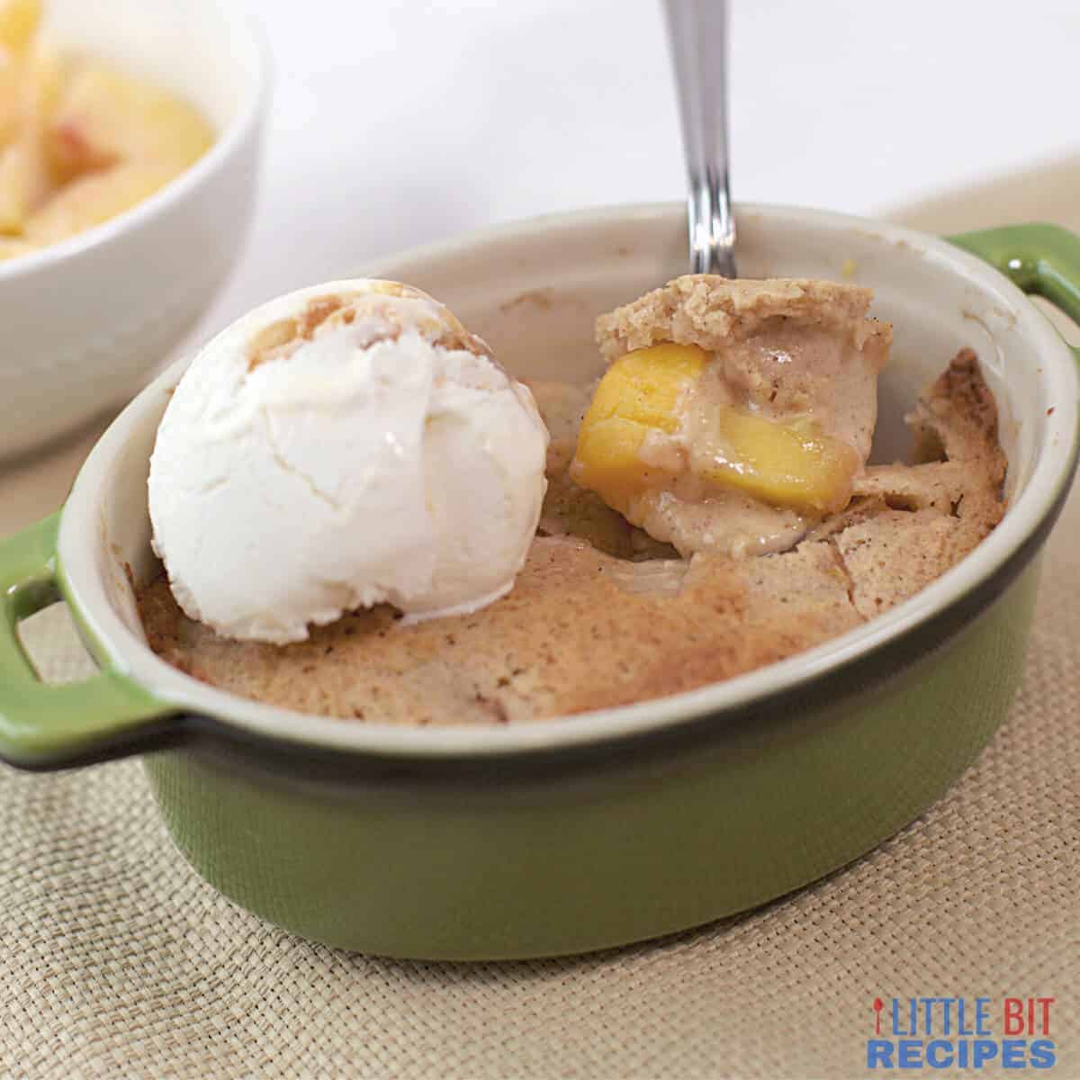 Peach cobbler with ice cream and peaches.