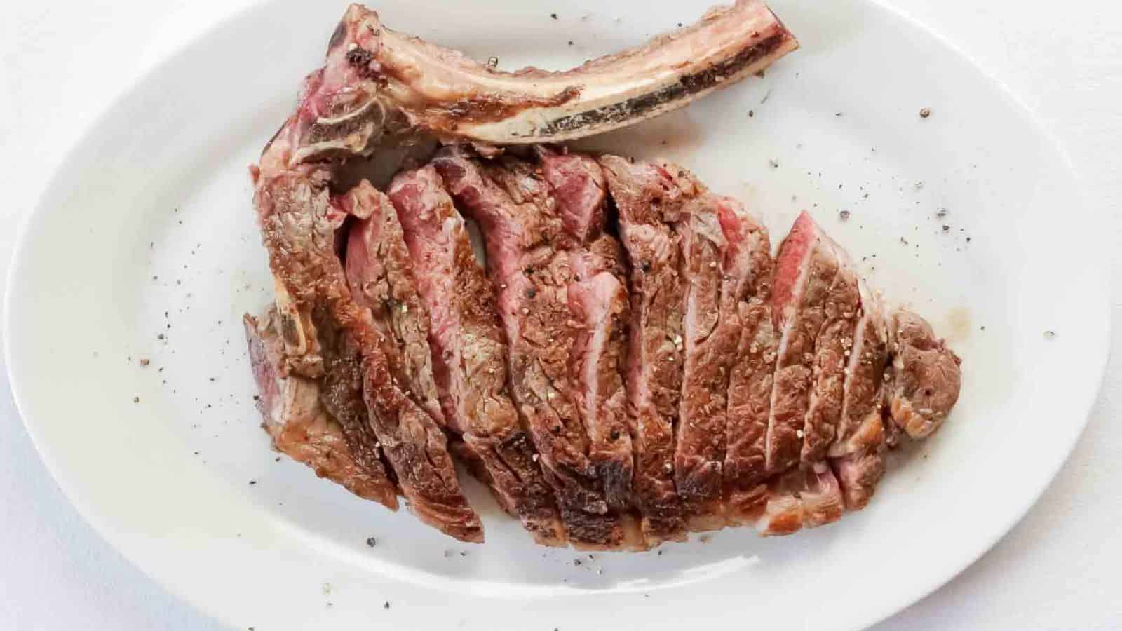 Meat cut into slices on a white plate.